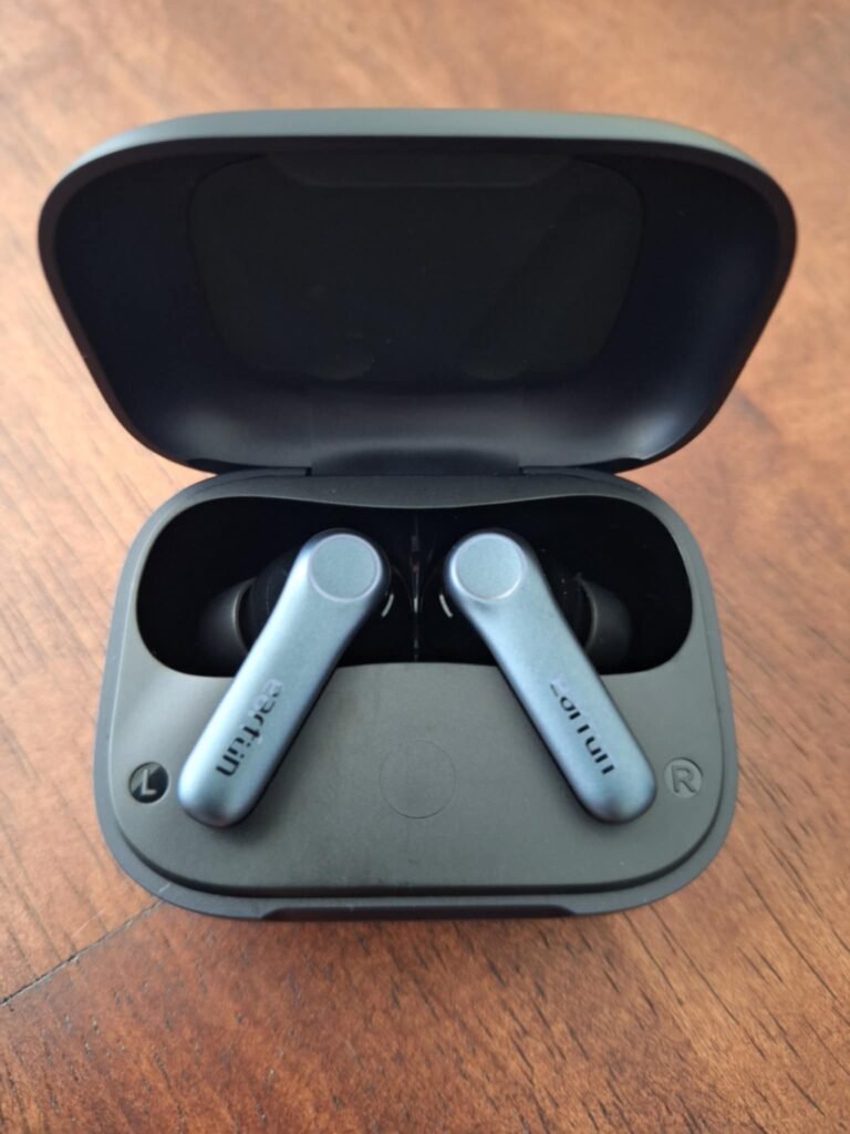 EarFun Air Pro 4 wireless earbuds in charging case on wooden desk